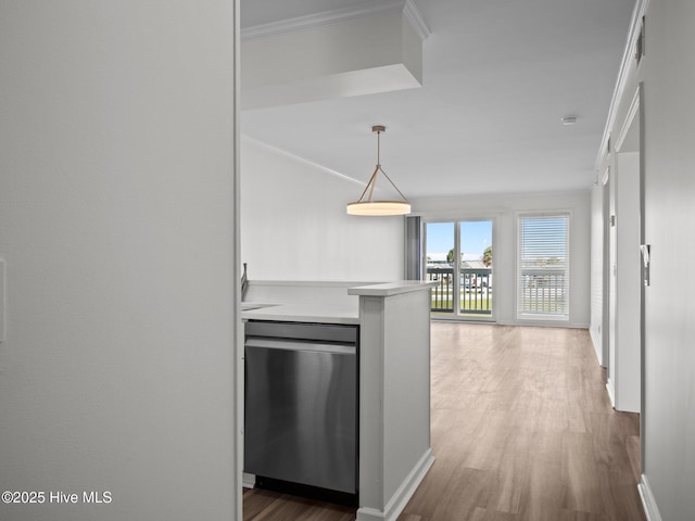 hallway with ornamental molding, wood finished floors, and baseboards
