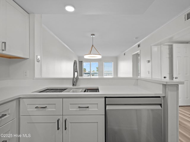 kitchen featuring dishwasher, a sink, light countertops, white cabinets, and crown molding