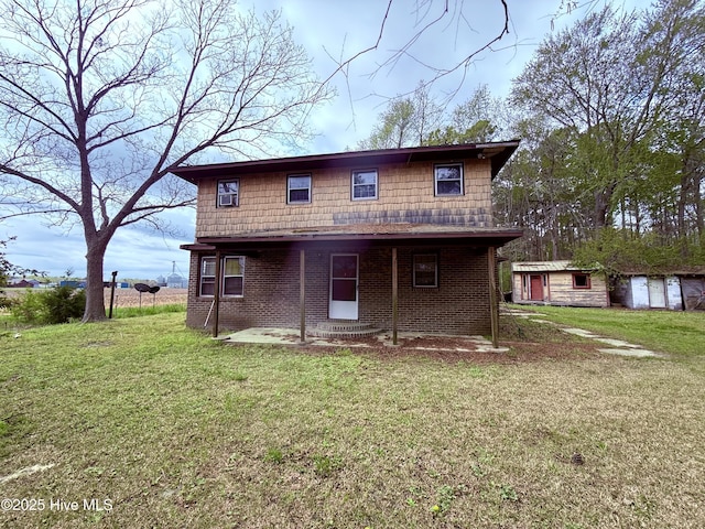 610 S Main St, Roxobel, NC 27872 - view of front of house with an outdoor structure, brick siding, a storage unit, and a front lawn