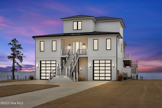 546 S Brightleaf Dr, Minnesott Beach, NC 28510 - view of front of house with stairs, a standing seam roof, concrete driveway, metal roof, and a garage