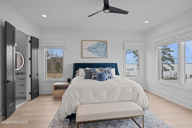 546 S Brightleaf Dr, Minnesott Beach, NC 28510 - bedroom with baseboards, multiple windows, and light wood-style floors