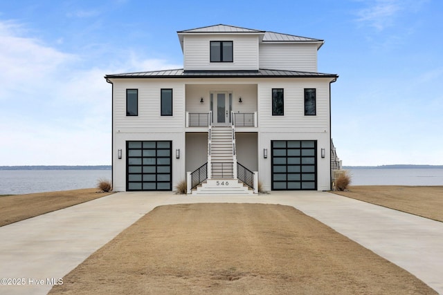 546 S Brightleaf Dr, Minnesott Beach, NC 28510 - view of front facade featuring a standing seam roof, stairway, metal roof, a water view, and a porch