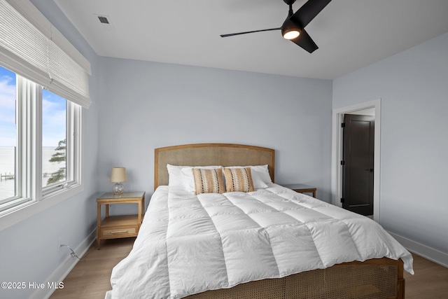 546 S Brightleaf Dr, Minnesott Beach, NC 28510 - bedroom with visible vents, baseboards, light wood-style floors, and ceiling fan