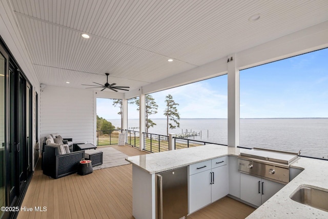 546 S Brightleaf Dr, Minnesott Beach, NC 28510 - wooden deck with area for grilling, a water view, a sink, and a ceiling fan