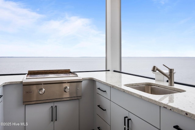 546 S Brightleaf Dr, Minnesott Beach, NC 28510 - kitchen featuring a water view, a sink, and light stone counters