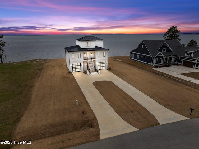 546 S Brightleaf Dr, Minnesott Beach, NC 28510 - view of front of property featuring concrete driveway, a standing seam roof, stairway, metal roof, and a water view