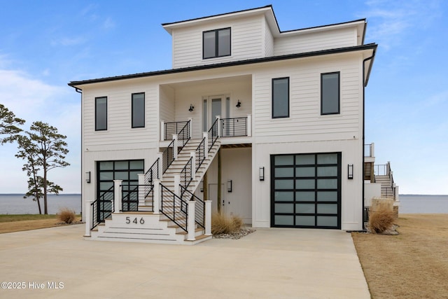 546 S Brightleaf Dr, Minnesott Beach, NC 28510 - view of front of property with stairs, a porch, an attached garage, and concrete driveway