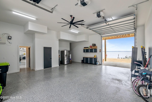 546 S Brightleaf Dr, Minnesott Beach, NC 28510 - garage featuring baseboards, stainless steel refrigerator with ice dispenser, and a garage door opener
