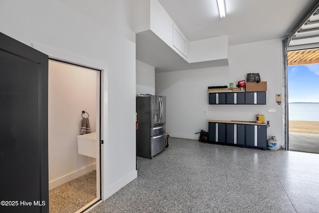 546 S Brightleaf Dr, Minnesott Beach, NC 28510 - garage featuring baseboards and stainless steel fridge
