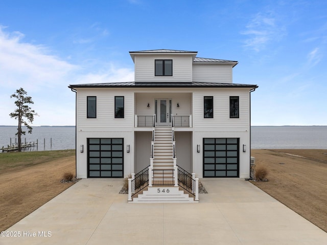 546 S Brightleaf Dr, Minnesott Beach, NC 28510 - view of front facade featuring metal roof, stairway, a standing seam roof, driveway, and a porch