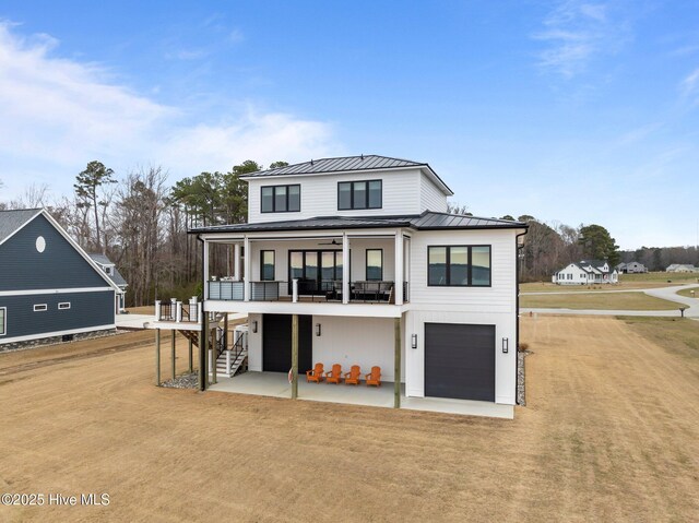 546 S Brightleaf Dr, Minnesott Beach, NC 28510 - rear view of property with a standing seam roof, stairway, metal roof, a patio, and dirt driveway