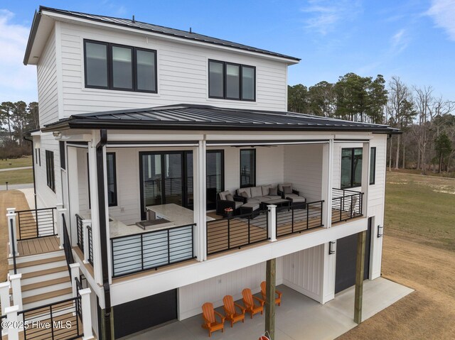 546 S Brightleaf Dr, Minnesott Beach, NC 28510 - rear view of property with outdoor lounge area, metal roof, an attached garage, and a standing seam roof