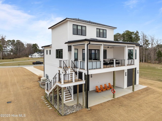 546 S Brightleaf Dr, Minnesott Beach, NC 28510 - view of front of house featuring stairway, an attached garage, driveway, ceiling fan, and a patio area