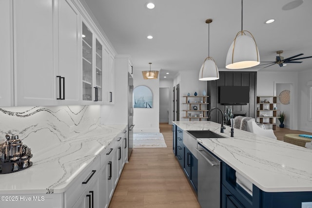 546 S Brightleaf Dr, Minnesott Beach, NC 28510 - kitchen featuring a sink, appliances with stainless steel finishes, open floor plan, ceiling fan, and blue cabinetry