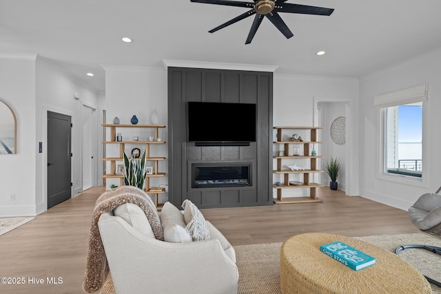 546 S Brightleaf Dr, Minnesott Beach, NC 28510 - living room with a fireplace, wood finished floors, ornamental molding, and a ceiling fan