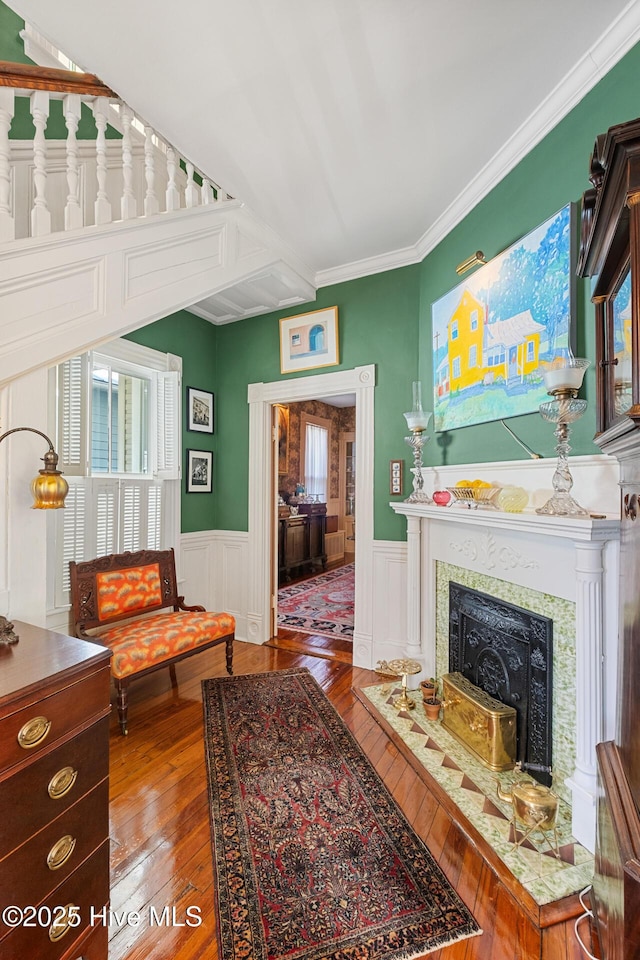 211 S 2nd St, Wilmington, NC 28401 - living room with hardwood / wood-style floors, wainscoting, a fireplace with flush hearth, ornamental molding, and a decorative wall