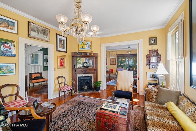 211 S 2nd St, Wilmington, NC 28401 - living room with wood finished floors, ornamental molding, a chandelier, baseboards, and a fireplace with flush hearth