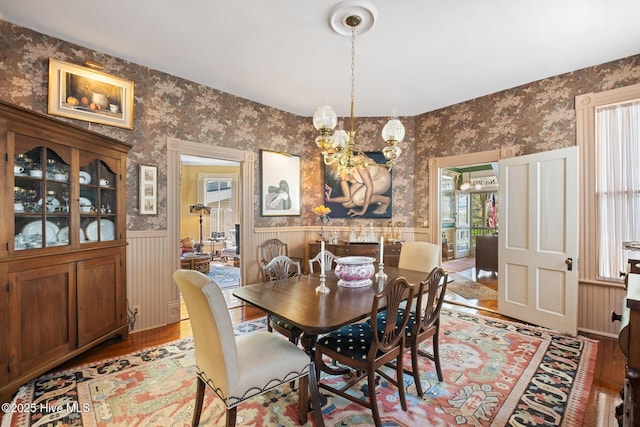 211 S 2nd St, Wilmington, NC 28401 - dining room with wallpapered walls, a wainscoted wall, light wood-style flooring, plenty of natural light, and a chandelier