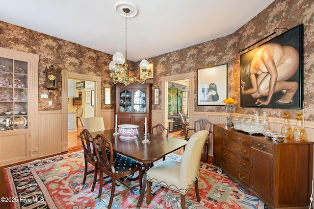 211 S 2nd St, Wilmington, NC 28401 - dining room featuring wainscoting, wallpapered walls, and a chandelier