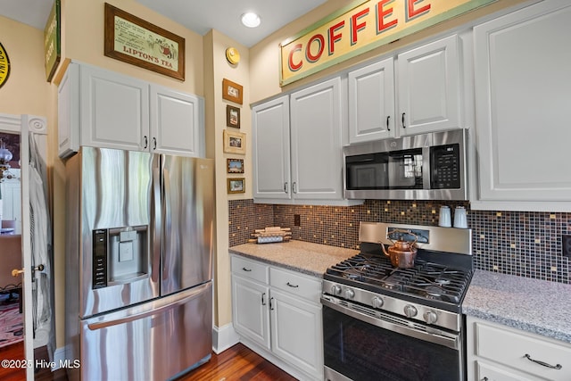 211 S 2nd St, Wilmington, NC 28401 - kitchen with appliances with stainless steel finishes, tasteful backsplash, and white cabinets