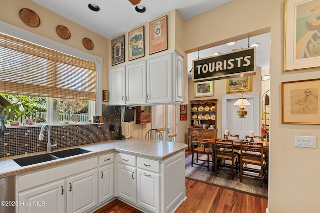 211 S 2nd St, Wilmington, NC 28401 - kitchen with a sink, tasteful backsplash, white cabinets, and dark wood finished floors