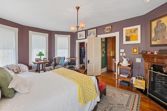 211 S 2nd St, Wilmington, NC 28401 - bedroom with wood finished floors, a chandelier, and baseboards