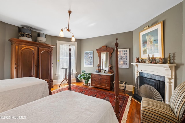 211 S 2nd St, Wilmington, NC 28401 - bedroom featuring wood finished floors, a fireplace, and baseboards