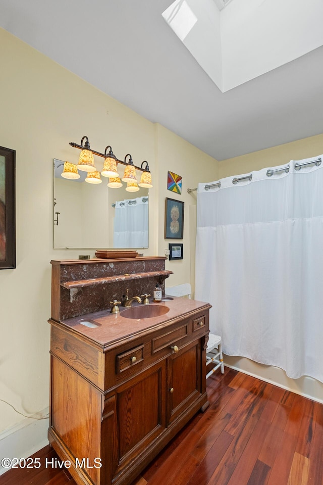 211 S 2nd St, Wilmington, NC 28401 - bathroom featuring vanity, wood finished floors, a skylight, and shower / bath combo with shower curtain