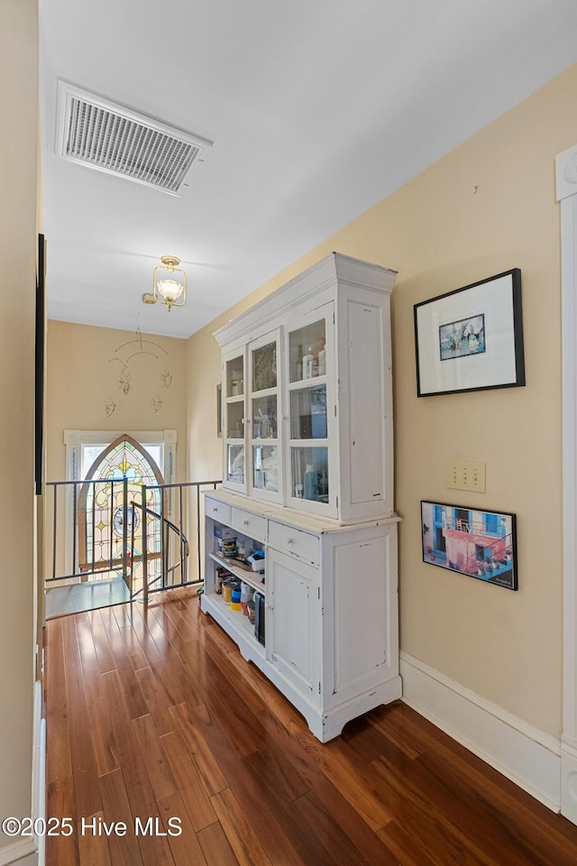 211 S 2nd St, Wilmington, NC 28401 - bar area with dark wood-style flooring, baseboards, and a chandelier