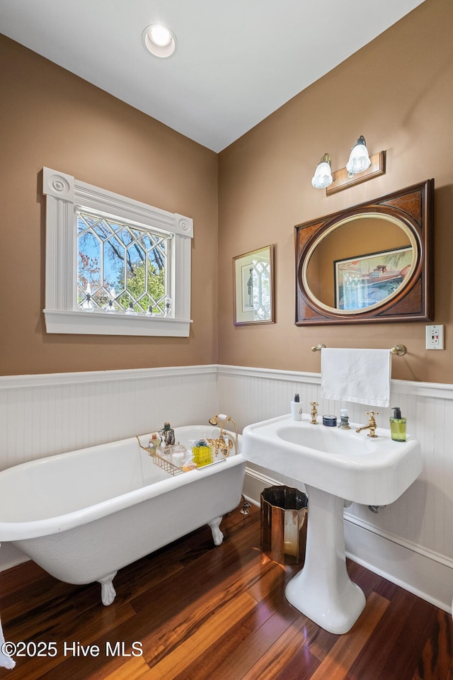 211 S 2nd St, Wilmington, NC 28401 - bathroom with a freestanding tub, wainscoting, and wood finished floors