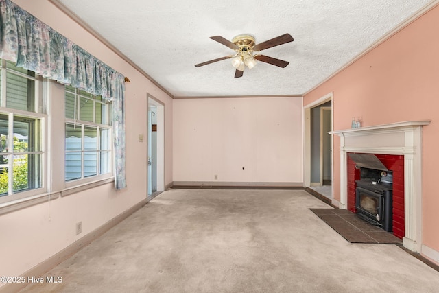 2109 Arendell St, Morehead City, NC 28557 - unfurnished living room with a wood stove, a textured ceiling, carpet, a ceiling fan, and ornamental molding