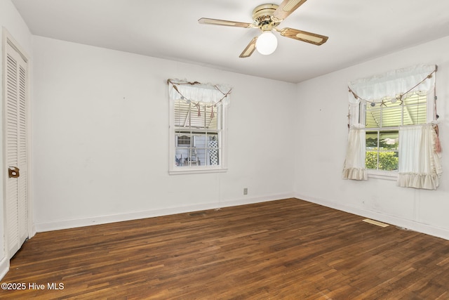 2109 Arendell St, Morehead City, NC 28557 - unfurnished bedroom featuring wood finished floors, a closet, baseboards, and a ceiling fan