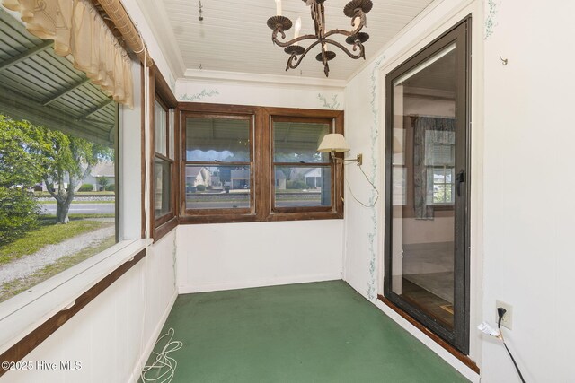 2109 Arendell St, Morehead City, NC 28557 - unfurnished sunroom featuring a chandelier, ornamental molding, and baseboards