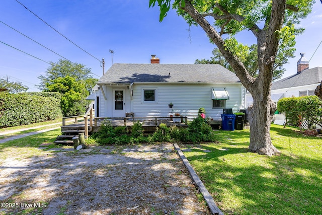 2109 Arendell St, Morehead City, NC 28557 - rear view of property featuring a wooden deck, a yard, and a chimney