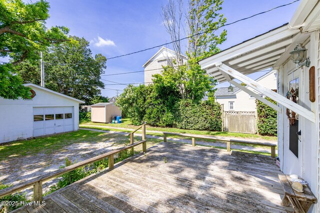 2109 Arendell St, Morehead City, NC 28557 - wooden terrace featuring an outbuilding, a garage, and driveway