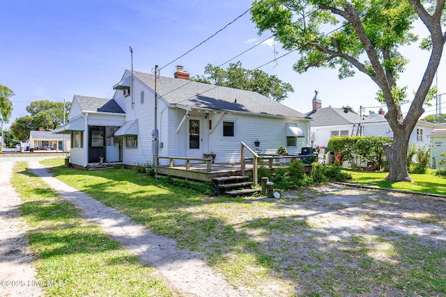 2109 Arendell St, Morehead City, NC 28557 - rear view of property with a deck, a lawn, a chimney, and a shingled roof