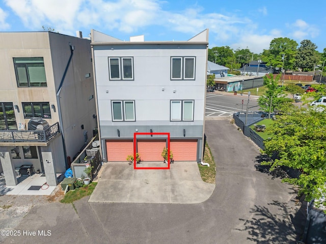 view of front of property featuring an attached garage and concrete driveway