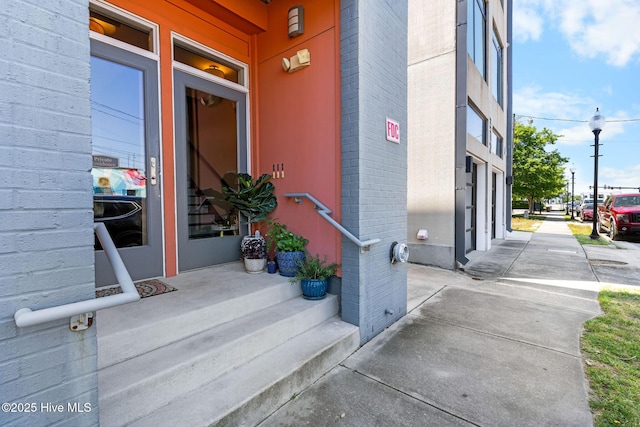 doorway to property with brick siding