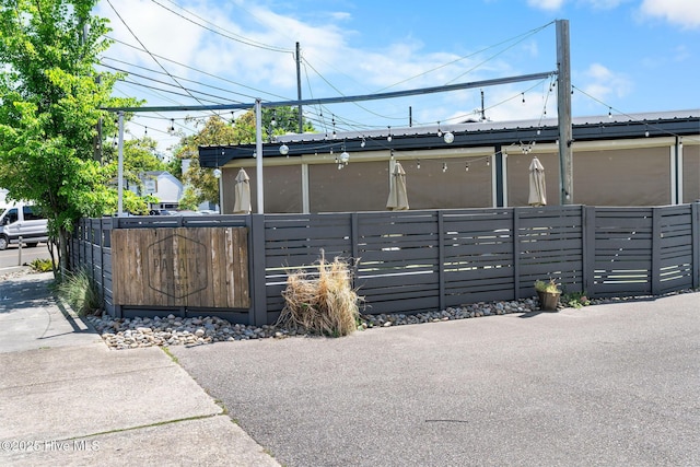 view of gate with a fenced front yard