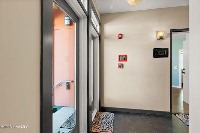 corridor featuring baseboards
