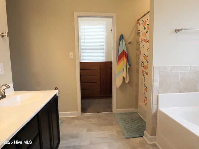 full bath with baseboards, a shower with curtain, vanity, and a bathing tub