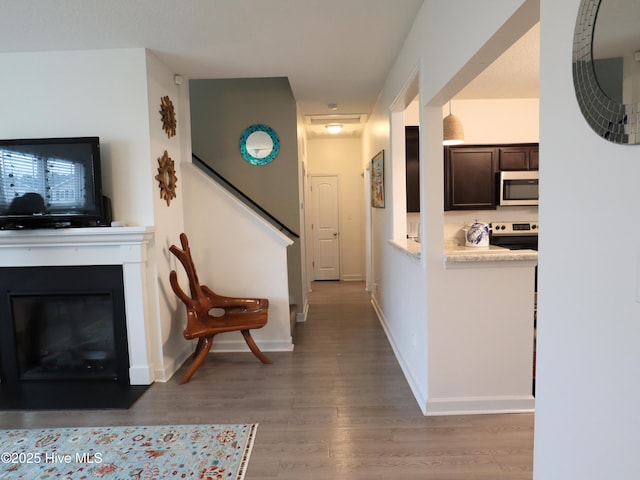 interior space with wood finished floors, stairs, and baseboards