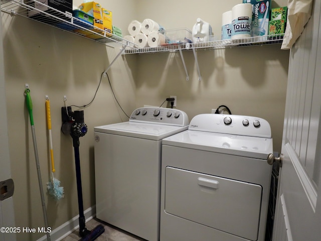laundry area featuring baseboards, laundry area, and independent washer and dryer