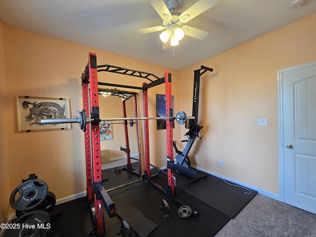 exercise area with ceiling fan and baseboards