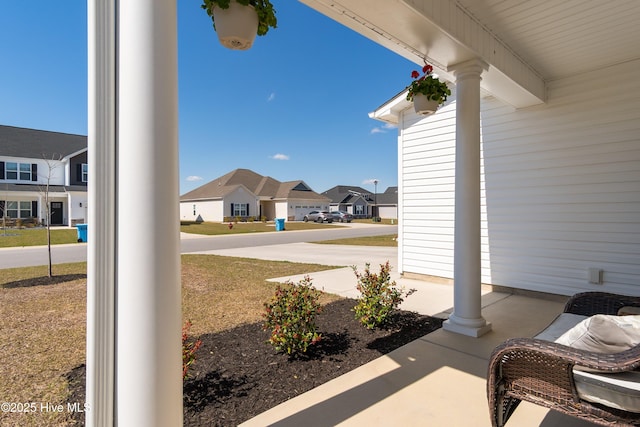 view of patio / terrace with a residential view and a porch