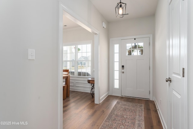foyer entrance with baseboards and wood finished floors