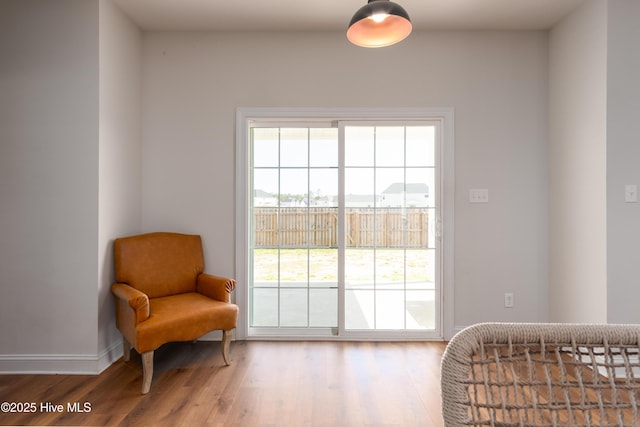 sitting room featuring baseboards and wood finished floors