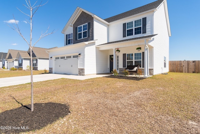 traditional home featuring concrete driveway, a front lawn, stone siding, fence, and a porch