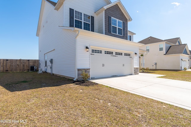 view of front of property with central AC unit, concrete driveway, a front lawn, an attached garage, and fence