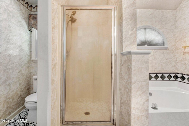full bath featuring a stall shower, a garden tub, and toilet